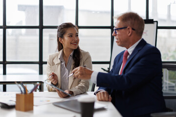 Two business talking at table in meeting room, discussing job tasks, teamwork in modern office workspace, sharing ideas for brainstorming. Stakeholders planning cooperation, marketing strategy

