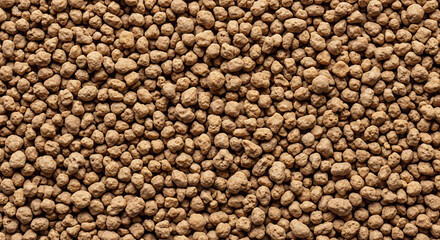 Textured brown pellets form a dense surface
