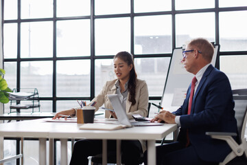 Two business talking at table in meeting room, discussing job tasks, teamwork in modern office workspace, sharing ideas for brainstorming. Stakeholders planning cooperation, marketing strategy
