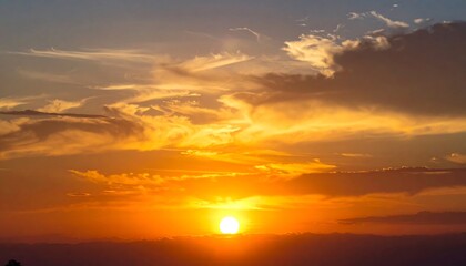 Golden orb illuminates a sky ablaze with swirling clouds at dusk