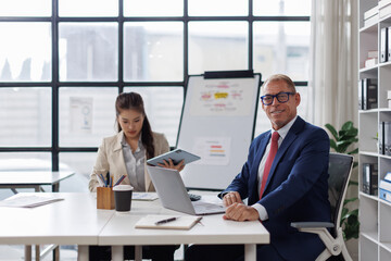 Two business talking at table in meeting room, discussing job tasks, teamwork in modern office workspace, sharing ideas for brainstorming. Stakeholders planning cooperation, marketing strategy
