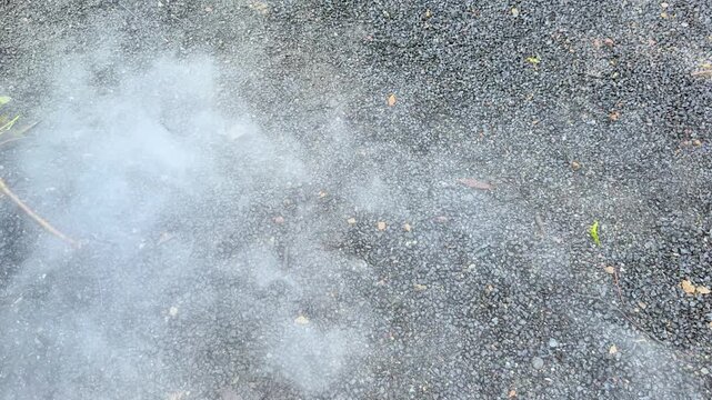 White Smoke or Fog Rolling Over Gravel Surface Outdoors