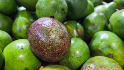 Fresh green avocados stacked together in a market display. Close-up texture highlights natural ripeness and organic produce, perfect for themes of healthy food, nutrition, and freshness.