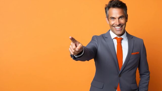 Confident businessman pointing forward with smile