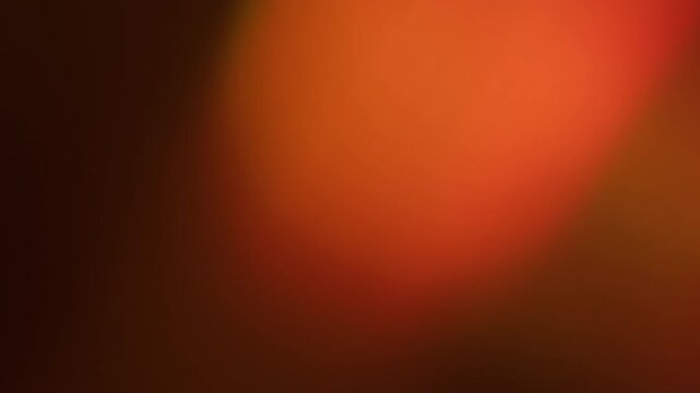 Defocused leak. Lens glow reflection. Red orange beam film burn luminosity on dark background. Light color fade in abstract night.