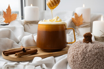 Pumpkin spiced latte morning warming coffee. Fall Drinks for Halloween Thanksgiving Holiday beverage Autumn spicy cinnamon flavor seasonal hot drinking in cozy orange cup. Atmosphere of cold rainy