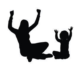 Happy mother sitting on the floor raising arms playing with her son toddler isolated silhouette on white background.