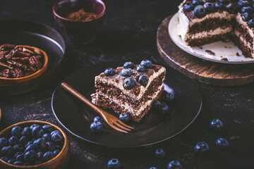 Homemade gluten free nut and chocolate cake with cream cheese and fresh blueberries