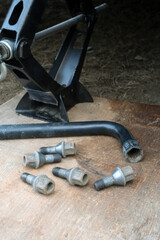 Car jack, lug wrench, and lug bolts for tire changing