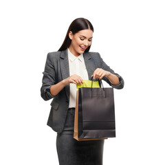 Happy businesswoman looks into shopping bags wearing a suit isolated on white background