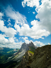 Spectacular view of Seceda ridgeline in the Dolomites, Italy. Dramatic limestone peaks rising above vibrant green slopes under a bright summer sky &mdash; a breathtaking natural masterpiece.