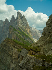 Spectacular view of Seceda ridgeline in the Dolomites, Italy. Dramatic limestone peaks rising above vibrant green slopes under a bright summer sky &mdash; a breathtaking natural masterpiece.