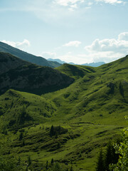 Green mountain landscape with clouds in Dolomites, Italy