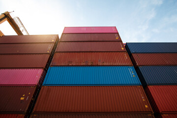 Stacked cargo containers in yard, and global logistics and freight.