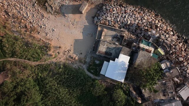 Aerial View of Coastal Village at Dusk with Rocky Shoreline at Lei Yue Mun Quarry