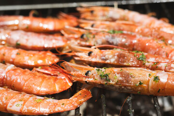 Grilled prawns with garlic and parsley on a barbecue