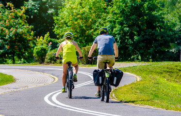 Naklejka premium Cyclists ride on the bike path in the city Park 