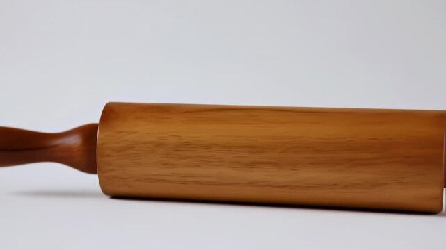 Light brown wooden rolling pin on a white background
