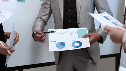 Businessman showing charts and graphs, explaining financial results to team, analyzing market trends, developing strategies, collaborating on projects, and making business decisions - Powered by Adobe