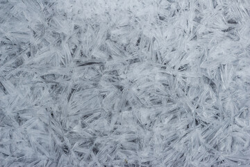 Intricate frozen river surface with jagged, crystalline ice shards creating a unique, abstract texture Cold weather pattern, natural winter beauty
