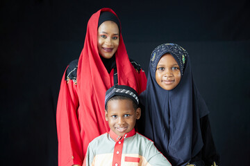 A beautiful Muslim family in traditional attire posing happily for a portrait, a depiction of love...