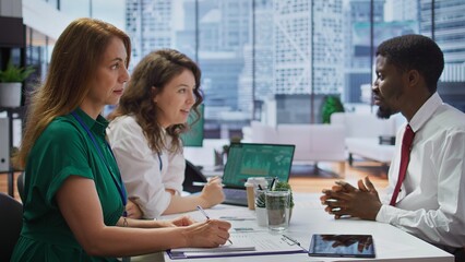 Obraz premium HR recruiters interviewing a job seeker and taking notes during meeting, attending an interview and conducting an evaluation. Headhunters and applicant in recruitment process. Close up. Camera B.