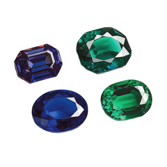 Four colorful, faceted gemstones on a dark background