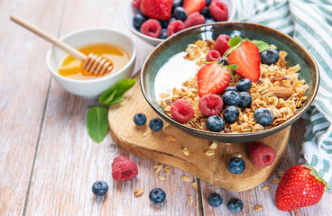 Healthy breakfast granola with fresh berries and honey
