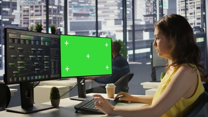 Computer scientist working, doing software debugging using mockup PC, troubleshooting errors. Woman in office fixing coding issues using green screen computer, solving tasks, camera B