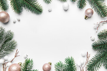 Christmas frame with pine branches and ornaments on white background
