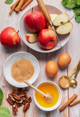 Baking ingredients for apple dessert on wooden table