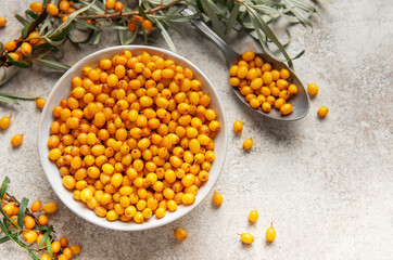 Sea buckthorn berries in bowl healthy eating concept