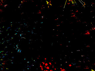 Dark backdrop showcases luminous splashes of red, blue, and yellow, creating an abstract effect