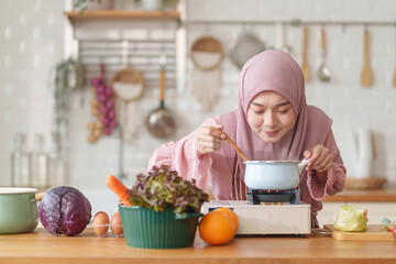 muslim woman in hijab prepare fresh vegetables and fruits to cook healthy food in the modern kitchen