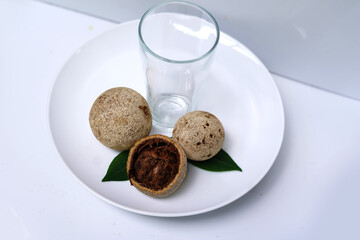 Woodapples with empty glass on white plate