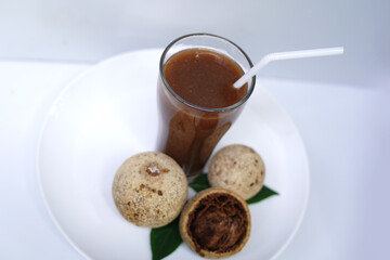Fresh Woodapple Juice Glass on White Plate.