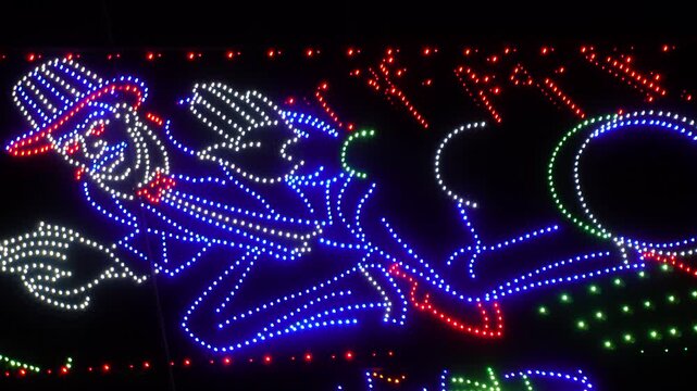 Led light installation of a character resembling the Monopoly man, often seen during festivals in India. 