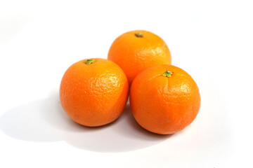 Three Bright Orange Fruits with White Background.