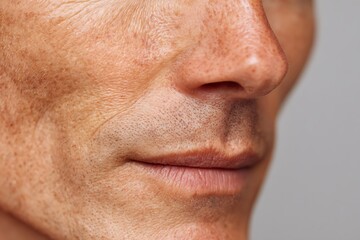 Obraz premium close-up of middle-age skin with visible pores and slight redness, dermatology concept