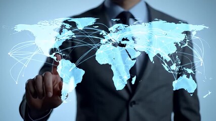 Professional businessman in a dark suit interacting with a luminous blue digital world map displaying global connections and network lines on a - Powered by Adobe