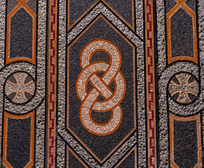 Byzantine colored mosaic on the wall in close-up.