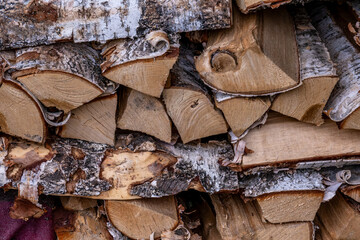 split birch firewood is stacked.
