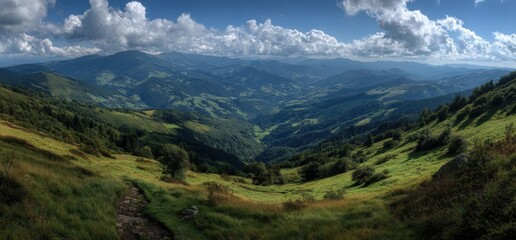 Obraz premium Panoramic view of lush green hills and valleys under a dramatic sky with fluffy clouds, showcasing the beauty of nature and the tranquility of the landscape