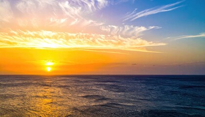 Obraz premium Dramatic sunset over calm ocean, vivid colors painting the sky