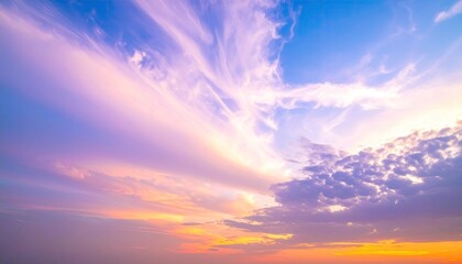 Obraz premium Beautiful gradient sky with vibrant hues of pink, orange, purple, and blue. Soft clouds