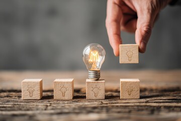 Illuminating Ideas Building Blocks Constructing Bright Innovations and Creativity Exploring Novel Concepts Laying Foundation for Success with Symbolic Light Bulb as Focal Point on Wooden Surface