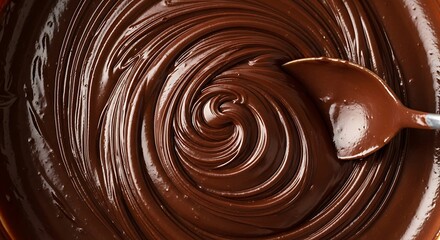 Closeup of Rich Glossy Dark Chocolate Ganache Being Swirled and Mixed with a Spoon