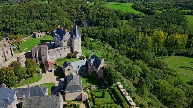 Ch&acirc;teau de Sainte-Suzanne, medieval castle and lush green landscape in Mayenne, France. Aerial drone panoramic view