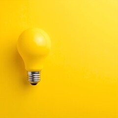 A vibrant yellow light bulb mounted on a textured white wall, casting a warm glow that enhances the cozy atmosphere of the room.