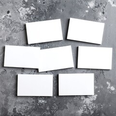 A pristine sheet of blank white paper lies flat on a textured gray background, showcasing its smooth surface and subtle shadows, inviting creativity.